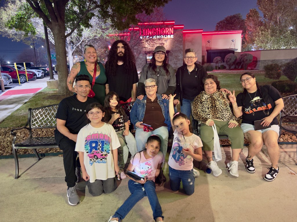 Picture of 11 people of multi-generations with the matriarch in the middle